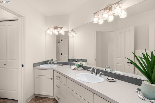 342 NW 84th Pl, Portland, OR 97229 - bathroom featuring double vanity, wood finished floors, and a closet