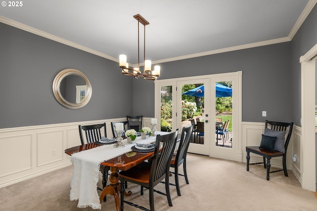 342 NW 84th Pl, Portland, OR 97229 - dining area with french doors, light colored carpet, crown molding, a chandelier, and a wainscoted wall