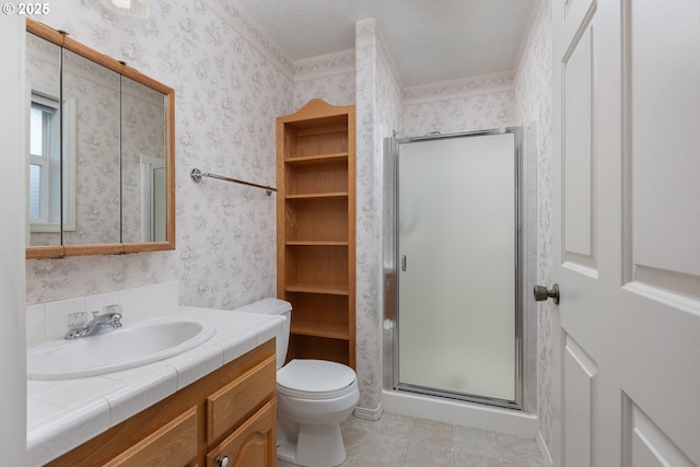 full bathroom featuring wallpapered walls, toilet, a stall shower, vanity, and tile patterned floors