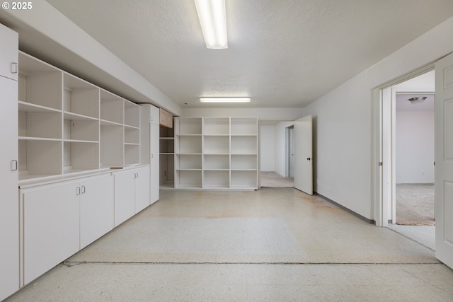 unfurnished room with light speckled floor and a textured ceiling