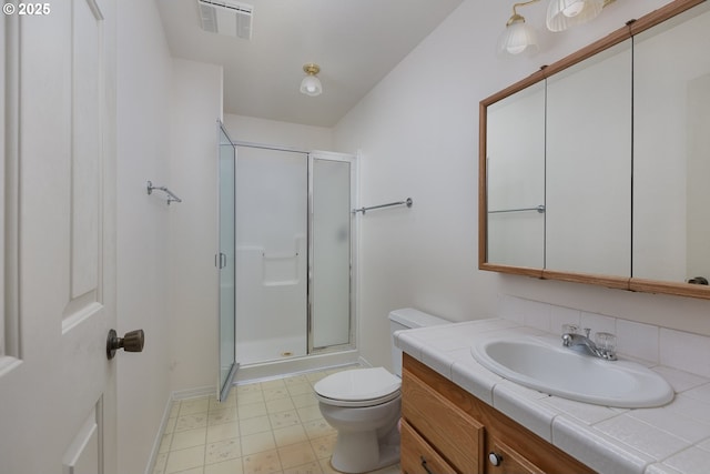 bathroom featuring a stall shower, visible vents, vanity, and toilet