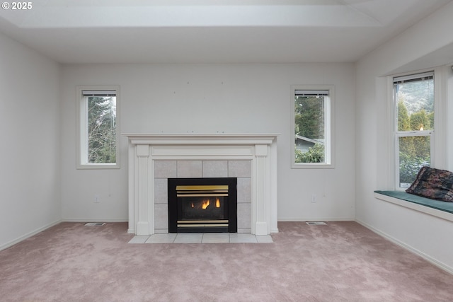 room details featuring carpet, baseboards, and a tile fireplace