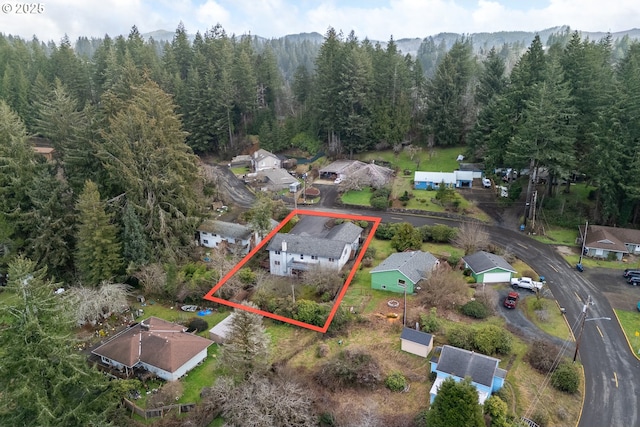 birds eye view of property featuring a wooded view