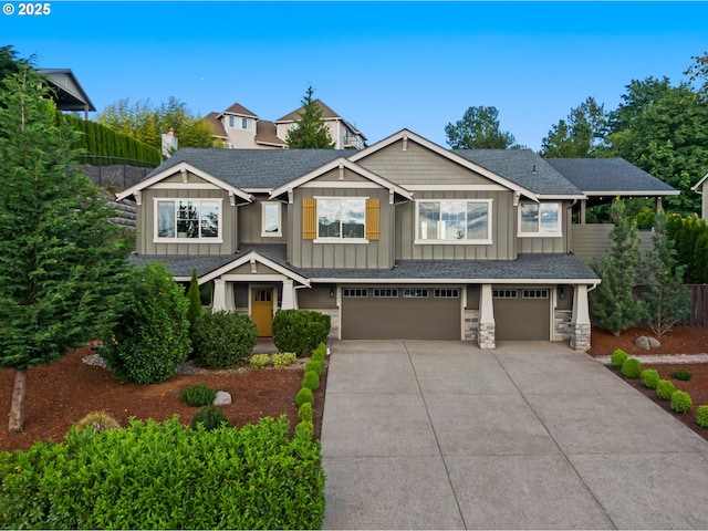 5309 NW 13th Cir, Camas, WA 98607 - craftsman house featuring board and batten siding, an attached garage, concrete driveway, stone siding, and a shingled roof