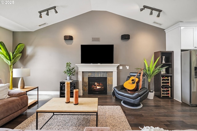 5309 NW 13th Cir, Camas, WA 98607 - living room with vaulted ceiling, rail lighting, dark wood-type flooring, a tiled fireplace, and baseboards