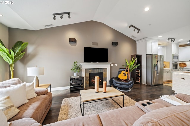 5309 NW 13th Cir, Camas, WA 98607 - living area featuring lofted ceiling, rail lighting, dark wood-type flooring, a tile fireplace, and baseboards