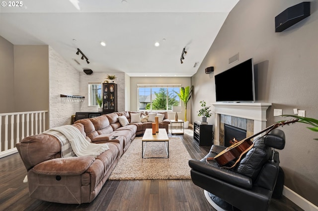 5309 NW 13th Cir, Camas, WA 98607 - living room featuring a tile fireplace, hardwood / wood-style floors, rail lighting, baseboards, and lofted ceiling