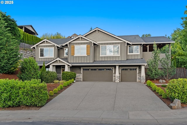 5309 NW 13th Cir, Camas, WA 98607 - craftsman-style house featuring board and batten siding, an attached garage, concrete driveway, and stone siding