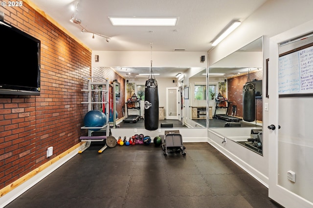 5309 NW 13th Cir, Camas, WA 98607 - exercise room featuring brick wall and baseboards