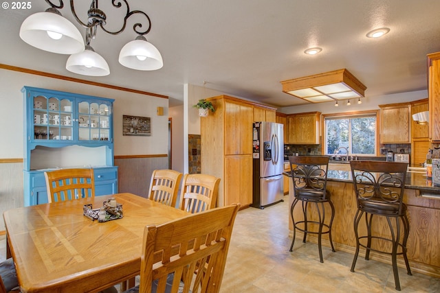 dining space with crown molding