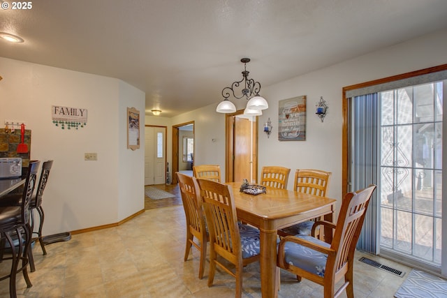 dining area featuring a chandelier