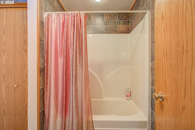 bathroom featuring shower / bathtub combination with curtain