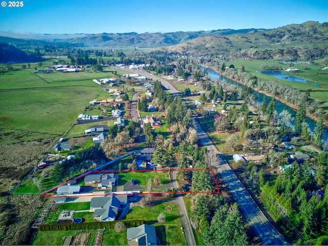 aerial view featuring a water and mountain view