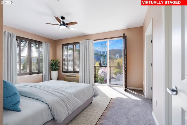 8712 N Decatur St Unit 302, Portland, OR 97203 - bedroom with carpet flooring, baseboards, a ceiling fan, a wall unit AC, and access to outside