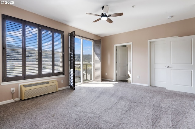 8712 N Decatur St Unit 302, Portland, OR 97203 - unfurnished bedroom featuring a wall mounted AC, access to outside, baseboards, and carpet
