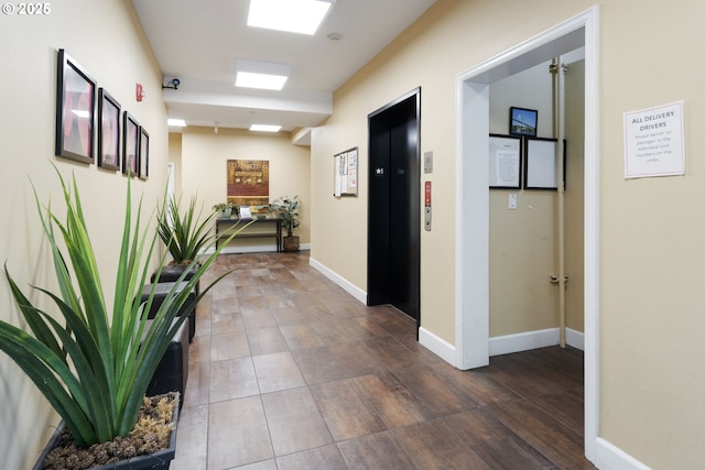 8712 N Decatur St Unit 302, Portland, OR 97203 - hallway with elevator, wood finished floors, and baseboards