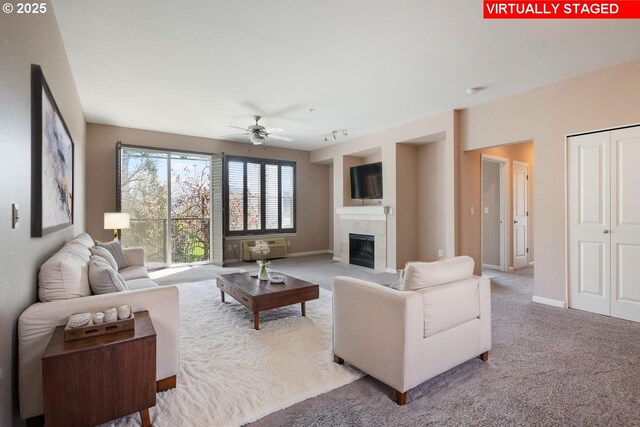 8712 N Decatur St Unit 302, Portland, OR 97203 - living room featuring carpet, ceiling fan, a tile fireplace, and baseboards