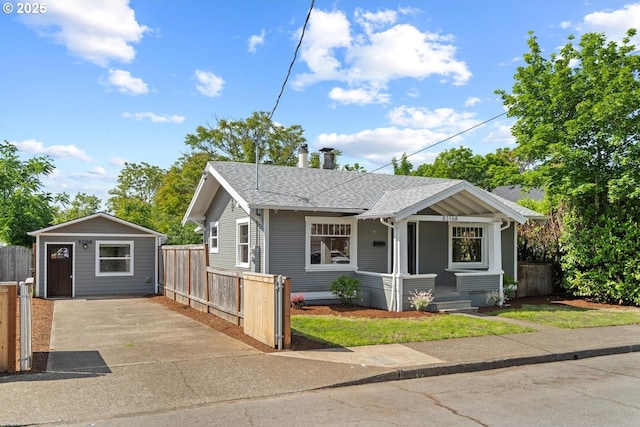 8316 SE Raymond Ct, Portland, OR 97266 - view of front facade with roof with shingles, covered porch, an outbuilding, and concrete driveway