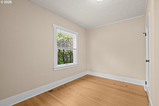 8316 SE Raymond Ct, Portland, OR 97266 - unfurnished room featuring baseboards, light wood-style flooring, and a textured ceiling