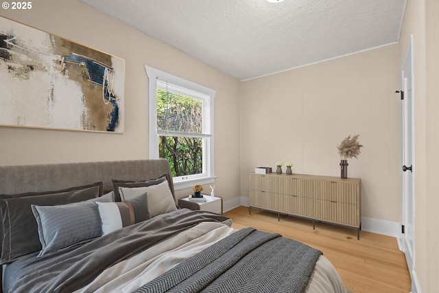 8316 SE Raymond Ct, Portland, OR 97266 - bedroom featuring wood finished floors, baseboards, and a textured ceiling