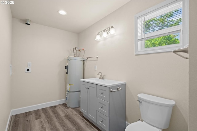 8316 SE Raymond Ct, Portland, OR 97266 - bathroom featuring water heater, toilet, wood finished floors, vanity, and recessed lighting