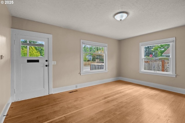 8316 SE Raymond Ct, Portland, OR 97266 - entrance foyer with wood finished floors, baseboards, and a textured ceiling