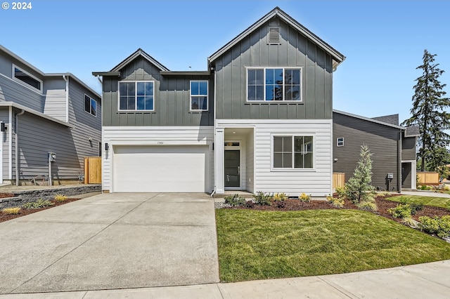 view of front of home featuring a front yard and a garage