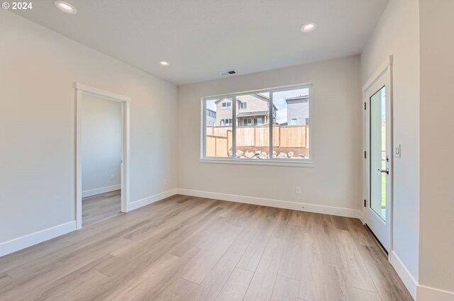 spare room with light wood-type flooring