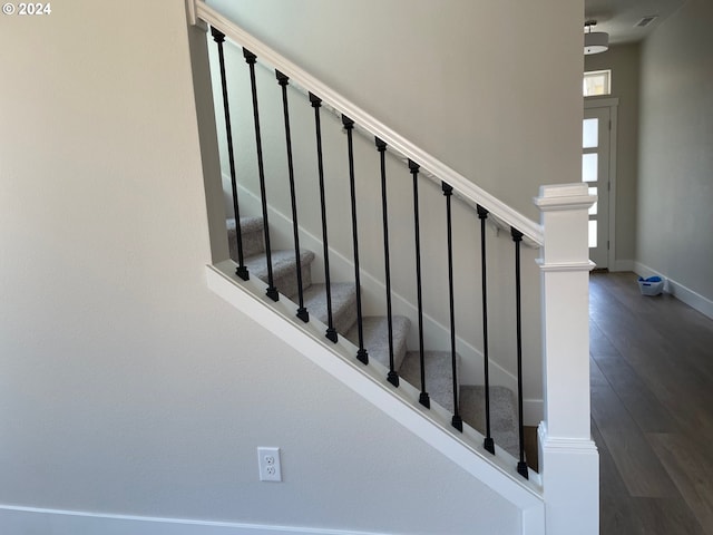 staircase featuring wood-type flooring