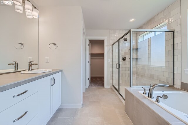 bathroom with vanity, tile patterned flooring, and separate shower and tub