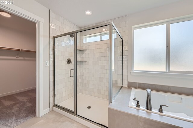 bathroom featuring independent shower and bath and tile patterned flooring