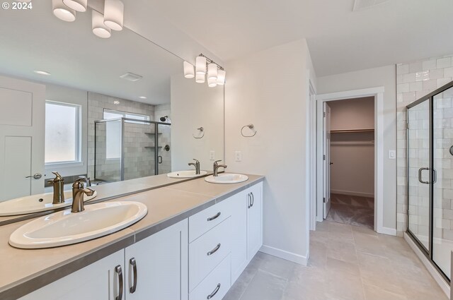 bathroom featuring walk in shower, tile patterned flooring, and vanity