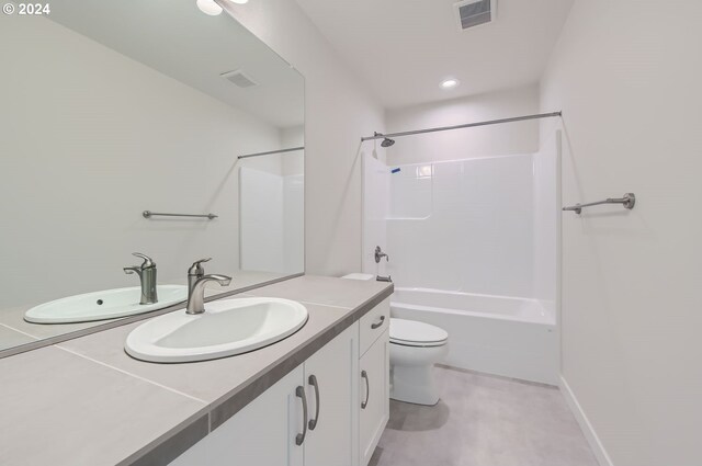 full bathroom featuring bathing tub / shower combination, vanity, and toilet