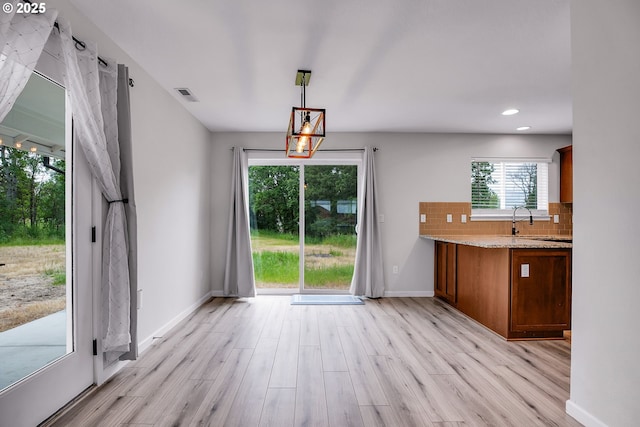 100 Running Dogs Ln, Saint Helens, OR 97051 - unfurnished dining area with light wood-style flooring, a sink, baseboards, and recessed lighting
