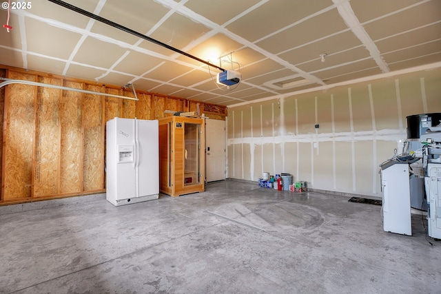 100 Running Dogs Ln, Saint Helens, OR 97051 - garage featuring white fridge with ice dispenser and a garage door opener