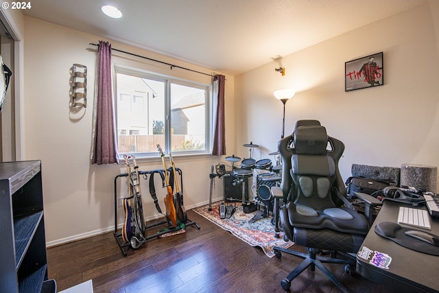 interior space with baseboards and wood finished floors