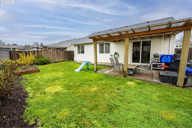 back of property featuring a yard, a patio, and a fenced backyard