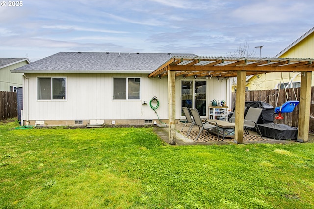 back of house with crawl space, a lawn, a pergola, and fence