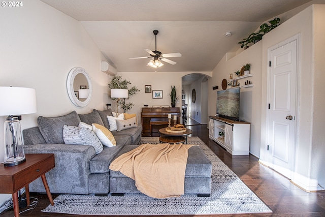 living area with a wall mounted air conditioner, lofted ceiling, dark wood-style floors, arched walkways, and a ceiling fan