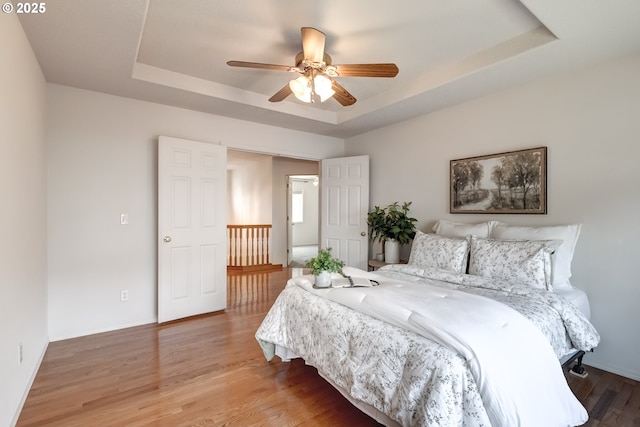 41653 NW Oak Way, Banks, OR 97106 - bedroom with a tray ceiling, wood finished floors, and a ceiling fan