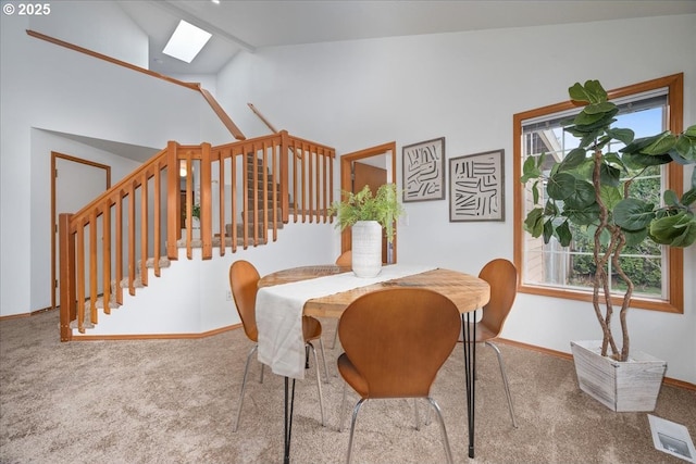 5249 NW 173rd Pl, Portland, OR 97229 - carpeted dining space with a skylight, plenty of natural light, high vaulted ceiling, and stairway