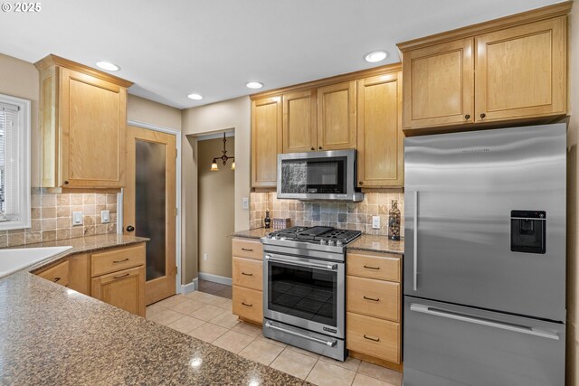 kitchen featuring appliances with stainless steel finishes, light tile patterned floors, backsplash, recessed lighting, and baseboards