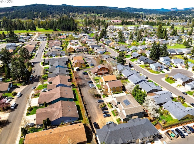 2000 S 8th St, Cottage Grove, OR 97424 - aerial view of property and surrounding area with nearby suburban area, a mountain backdrop, and a forest
