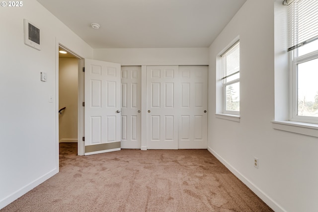 2000 S 8th St, Cottage Grove, OR 97424 - unfurnished bedroom with multiple windows, carpet flooring, and baseboards