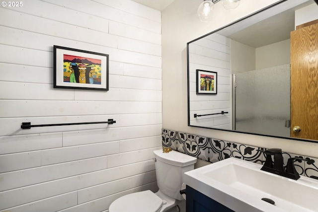 17692 Rogue Ln, Sunriver, OR 97707 - bathroom featuring toilet, vanity, wood walls, and a shower