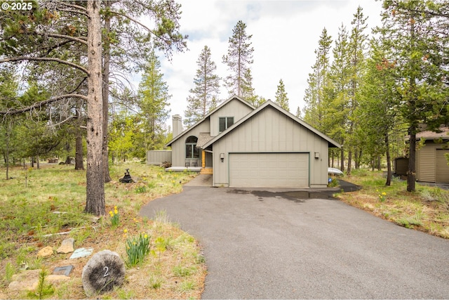 17692 Rogue Ln, Sunriver, OR 97707 - view of front of house featuring asphalt driveway, a chimney, and a garage