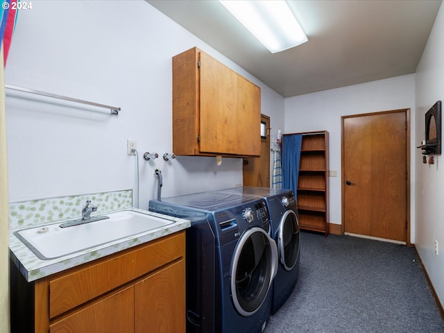 laundry room featuring dark colored carpet, a sink, cabinet space, and washer and dryer