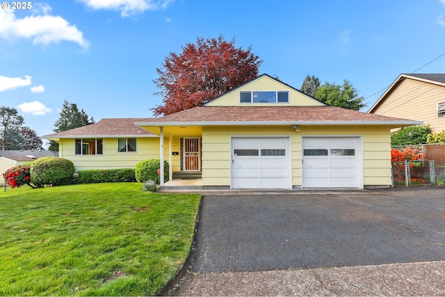 view of front of property with asphalt driveway, a garage, and roof with shingles