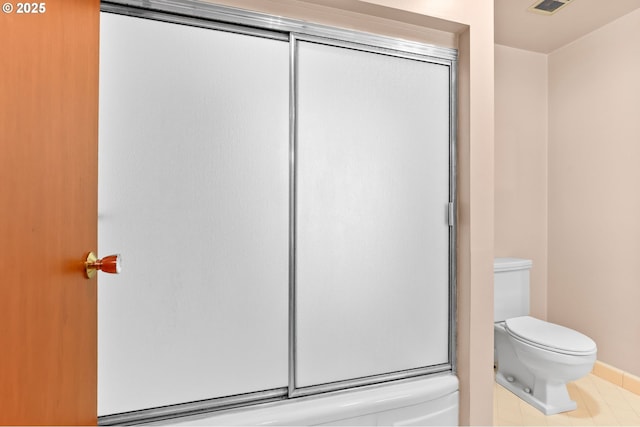 full bathroom with toilet, baseboards, and shower / bath combination with glass door