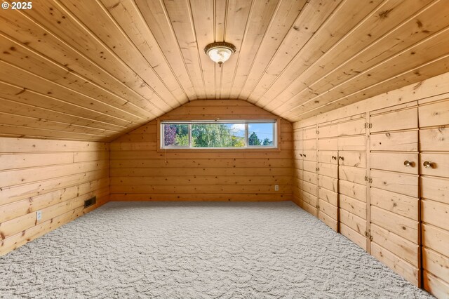 additional living space featuring carpet, lofted ceiling, wooden ceiling, and wood walls